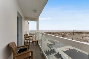 a balcony with chairs and a view of an airport at 9103 Atlantic Ave, Unit 415 in Wildwood Crest