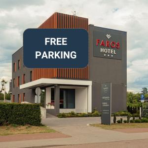 a building with a free parking sign in front of it at Hotel Faros Gdansk Airport in Gdańsk-Rębiechowo