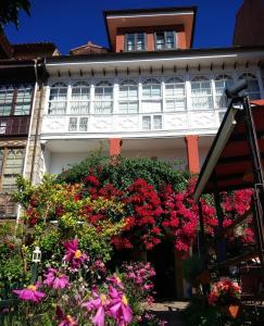 a building with a bunch of flowers in front of it at Mar Del Sueve in Colunga