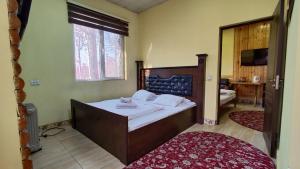 a bedroom with a bed and a large window at Diamond Hotel Dushanbe in Dushanbe