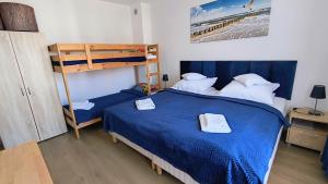 Łóżko lub łóżka w pokoju w obiekcie La Mer Pokoje i Apartamenty
