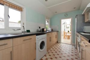 a kitchen with a washer and dryer in it at Gorgeous Georgian House in Canterbury