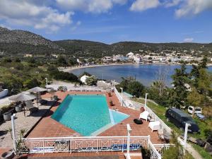 a swimming pool with a view of a body of water at Oneiro glico in Agia Marina Aegina