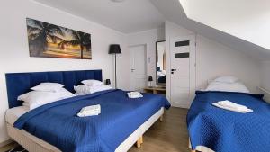 Łóżko lub łóżka w pokoju w obiekcie La Mer Pokoje i Apartamenty