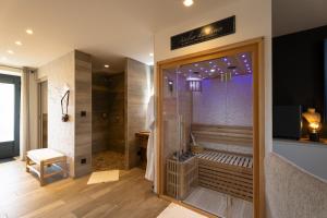 a bathroom with a walk in shower and a walk in shower at La Suite SPA privatif du Moulin in Saint-Laurent-dʼAndenay