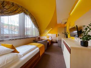 um quarto de hotel com duas camas e uma janela em Hotel Mayer Alsóörs em Alsóörs