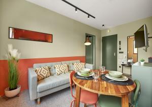 a living room with a table and a couch at SmartApart Óbuda in Budapest