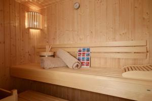a sauna with a bench in a wooden room at Sonnenweg 46-2 CINDY in Heringhausen