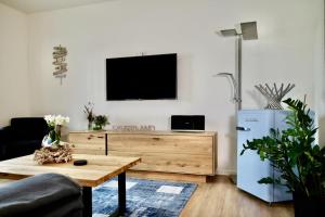 a living room with a tv and a coffee table at Sonnenweg 46-2 CINDY in Heringhausen