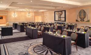 a large room filled with tables and chairs at Auberge du Jeu de Paume in Chantilly