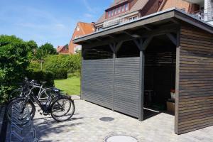 a garage with two bikes parked in it at Strandperle im Achterhus in Juist