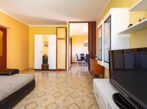 a hotel room with a bed and a flat screen tv at Apartment Serđa in Ugljan