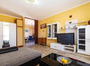 a living room with a couch and a flat screen tv at Apartment Serđa in Ugljan +15 photos