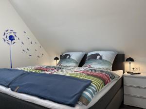 a bedroom with two beds with blue comforters at Am Kutterhafen 17 - HAFENGLÜCK in Fedderwardersiel