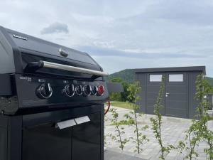 a black stove top oven sitting in a backyard at Diemelblick 17 in Heringhausen