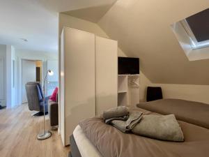 a bedroom with two beds and a tv in it at Kellenhusen Tor 24 in Kellenhusen