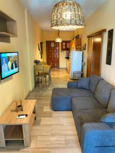 a living room with a couch and a table at Helens Apartment in Tolo