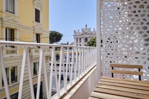 a balcony with a bench and a building at San Giovanni Retreat in Rome