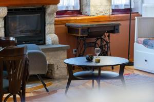 a living room with a table and a piano at Βερβερίτσα in Monodendri