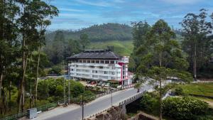 a building on the side of a road next to a road at HillView Munnar in Munnar