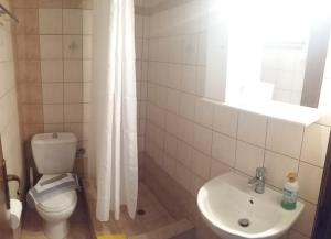 a bathroom with a toilet and a sink at Stella Maisonettes in Ammouliani