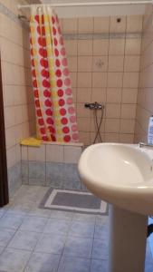 a bathroom with a sink and a shower curtain at Stella Maisonettes in Ammouliani