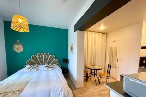 Ένα ή περισσότερα κρεβάτια σε δωμάτιο στο Le Balinais - Centre-ville