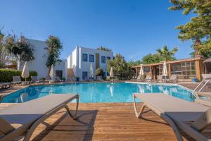 a swimming pool with tables and chairs in a resort at Costa Bodrum City in Bodrum City