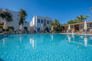 a large swimming pool with chairs and umbrellas at Costa Bodrum City in Bodrum City