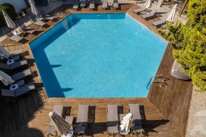 an overhead view of a swimming pool with chairs and a deck at Costa Bodrum City in Bodrum City