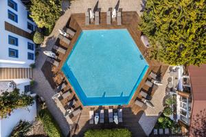 an overhead view of a swimming pool with lounge chairs at Costa Bodrum City in Bodrum City
