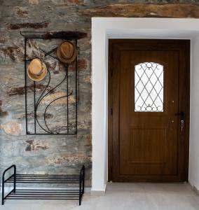 a wooden door in a room with a bench at Traditional stone build country house Shale 