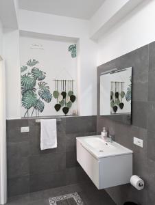 a bathroom with a white sink and a mirror at Villa Milicia in Altavilla Milicia