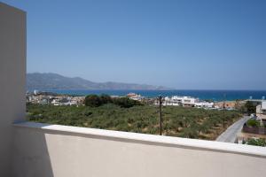 a view of the ocean from the balcony of a house at Kooba Luxury Apartments in Ayía Marína