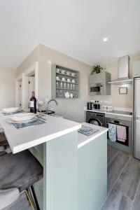 a kitchen with a white counter top and a refrigerator at Seaview Lodge Studio 'Sleeping 2 guests' in Burnfoot