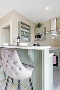 a kitchen with a counter and a bar with a chair at Seaview Lodge Studio 'Sleeping 2 guests' in Burnfoot