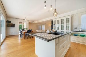 a kitchen with white cabinets and a counter top at Villa Isabella - Venice Retreat - Swimming Pool and Garden in Venice