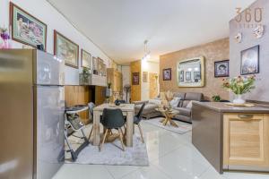 a kitchen and living room with a stainless steel refrigerator at Charming 2BR home in the heart of Marsaxlokk by 360 Estates in Marsaxlokk