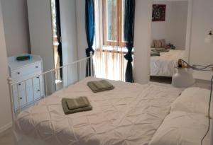 a bedroom with a bed with two pillows on it at Eli i Val in Rovinj