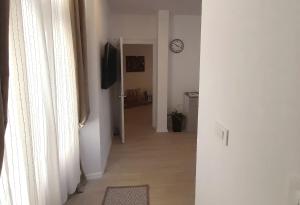 a hallway with a clock on the wall next to a door at Eli i Val in Rovinj