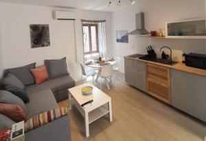a small living room with a couch and a kitchen at Eli i Val in Rovinj +8 photos