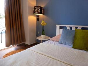 a bedroom with a bed and a lamp and a window at Apartments Lungo Mare Ulcinj in Ulcinj