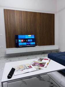 a living room with a tv and a coffee table at Prime Luxury Apartments in Lushnjë