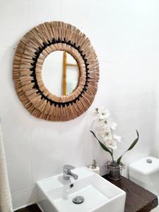 a bathroom with a sink and a mirror on the wall at 2 bedrooms house with city view enclosed garden and wifi at Vila Nova de Santo Andre in Giz