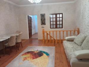 a living room with a couch and an umbrella on the floor at 2-storey apartment in Mardakan