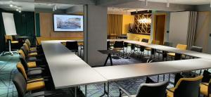 a conference room with white tables and chairs at ibis Styles Bucharest Erbas in Bucharest