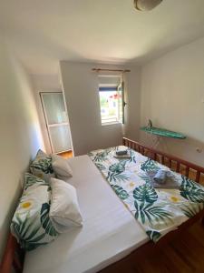 a small bedroom with a bed with a white bedspread at Apartments TEA in Trebinje