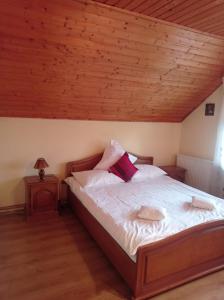 a bedroom with a bed with a wooden ceiling at Casa de Vacanta Eva in Stoeneşti +30 photos