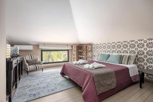 a bedroom with a large bed and a television at Casa Mediterranea Attitudine By DomuSicily in Mondello +86 photos