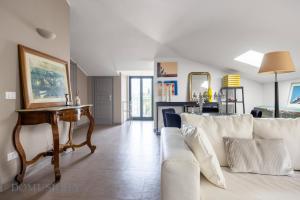 a living room with a couch and a table at Casa Mediterranea Attitudine By DomuSicily in Mondello